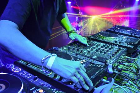 Club DJ spanning on decks